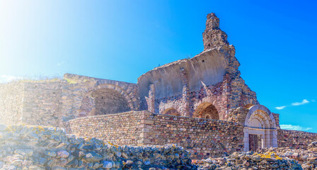 View of the ruins of medieval fortress on sunlight in Roses, Catalonia, northern Spain