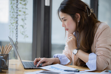 Asian businesswoman are stressed and tired from work at desk in the office, feeling sick at work,...