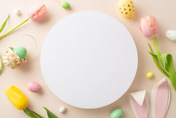 Festive Spring vibes. top view of cheerful eggs, playful bunny ears, and fresh tulips arranged on a calming beige base, offering a blank circular area for personalized messages or advertising - obrazy, fototapety, plakaty