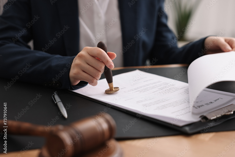 Canvas Prints Notary sealing document at table in office, closeup