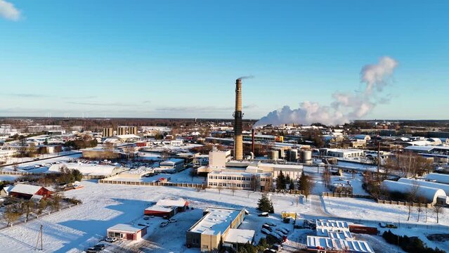 Smoke fumes coming out of Industrial building in the city in winter, Lithuania, Germany