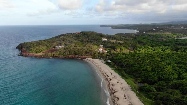 Levera beach in grenada with lush foliage and clear waters, aerial view