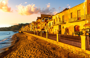 morning sunrise landscape on a city emnarkment with beach and sea coast and beautiful mediterranean street with buildings