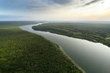 Aerial view of the river and forest at sunset. Summer landscape.