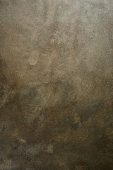 Brown textured surface with golden hue. Stone imitation. Top view.