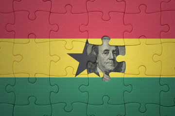 puzzle with the national flag of ghana and usa dollar banknote. finance concept