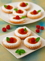 Cookies with mango jelly and raspberries.