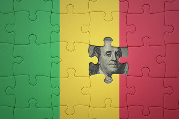 puzzle with the national flag of mali and usa dollar banknote. finance concept