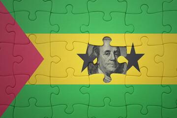 puzzle with the national flag of sao tome and principe and usa dollar banknote. finance concept