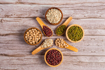Mung beans, Red kidney beans, Chickpeas source and peeled barley in a basket wooden isolated on wood background
