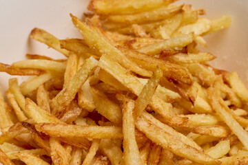 fried potatoes with parmesan cheese in a bowl.