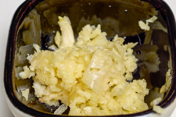 crushed garlic in a bowl prepared to be added to food as an ingredient.