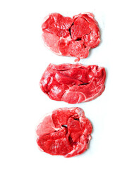 Three uncooked boneless lamb leg steak on white background. Premium high quality meat product of agriculture industry. Butcher craft and skill. Food supply chain.