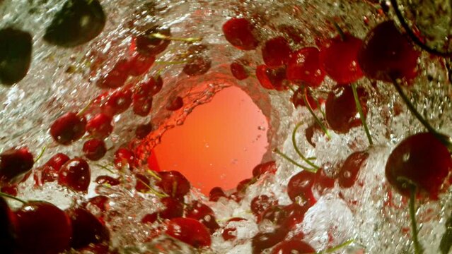 Super Slow Motion of Water Wave with Cherries. Water Surf Wave Rotating Around and Creating Tunnel Shape. Filmed on high speed cinema camera, 1000 fps.
