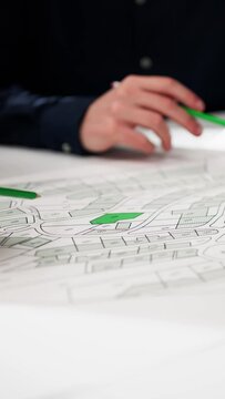 Close-up Of Human Hand Holding Pencil Over Paper Cadastre