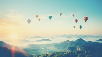 Fototapeta premium balloons over green mountains, in the sunset light