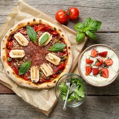 Raw vegan pizza and smoothie bowl on wooden table at restaurant. Food photography concept, top view