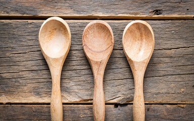 The Three wooden spoons on a wooden table. Selective focus