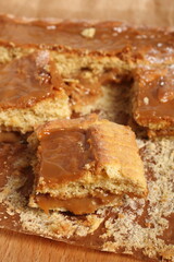 Shortcrust pastry cake covered with fudge caramel cream. Mazurek, Poland.