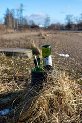 Discarded Green Glass Bottles in Urban Wasteland Highlighting Environmental Issues