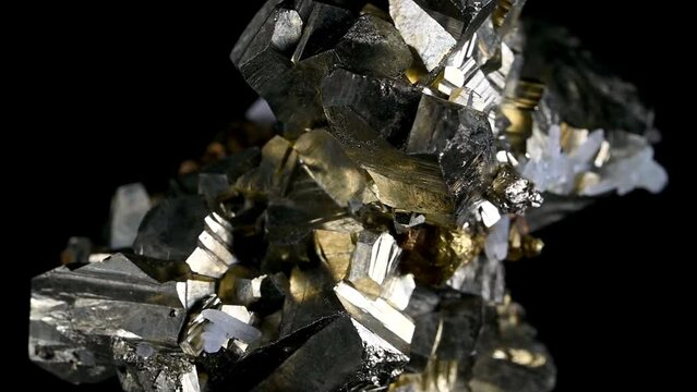 Iron Pyrite (fool's gold) cubic crystals and quartz rotating against a black background