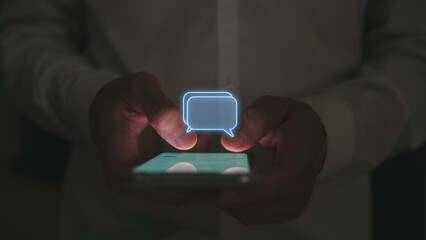 Social media marketing concept. low light shot Man hand using smartphone typing, chatting...
