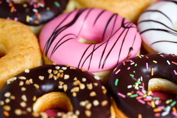 assorted donuts with chocolate frosting, topping sprinkles donuts Colorful variety and Variety of...