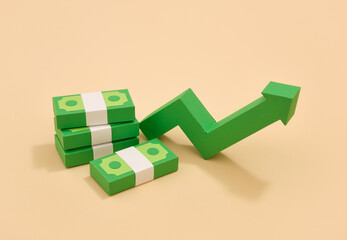 The green arrow grows upward and paper money. Profit and income.