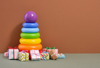 A brightly colored pyramid with a purple ball and lots of gifts. Copy space for text.