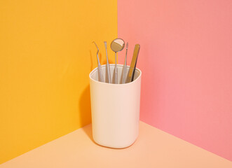 Dental instruments in a white stand. Minimalistic composition dental care.