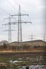 high-voltage pylons  in german industrial landscape