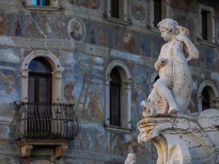 Obraz premium Neptune fountain in Dome place in front of the Medieval Cathedral of San Vigilio in Trento , Italy