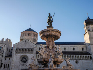 Obraz premium Neptune fountain in Dome place in front of the Medieval Cathedral of San Vigilio in Trento , Italy