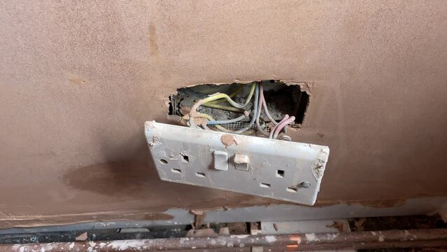 Newly plastered room with electric powerpoint sockets in wall