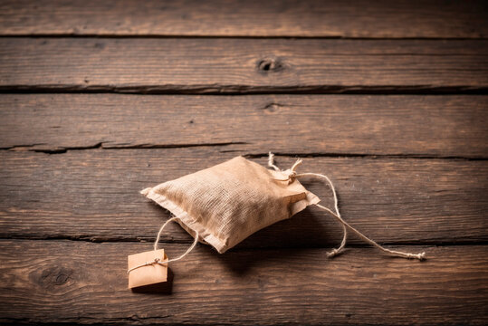 tea bag on an old wooden table, empty table, a lot of empty space FOR TEXT