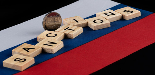 Coin with the symbol of the Russian ruble, the flag of Russia and the words 
