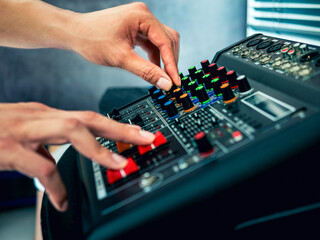 Sound engineer hands adjusting control sound mixer in recording, broadcasting studio,Sound mixer....