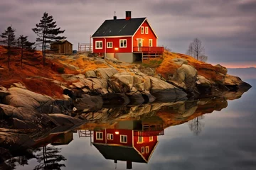 Papier Peint photo Europe du nord a red house on a rocky hill with a reflection of a tree