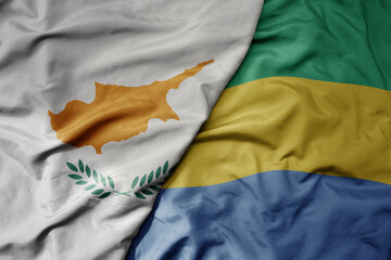 big waving national colorful flag of gabon and national flag of cyprus.