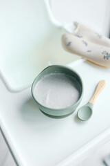 Buckwheat porridge for children in a plate. Feeding children healthy porridge