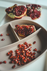 Baby eats pomegranate, first complementary feeding concept
