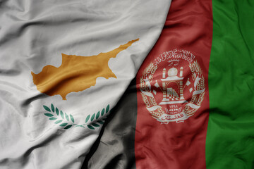 big waving national colorful flag of afghanistan and national flag of cyprus.