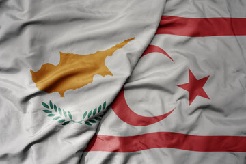 big waving national colorful flag of northern cyprus and national flag of cyprus.