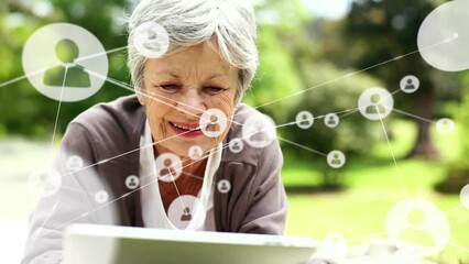 Animation of network of connections with icons over caucasian woman using tablet - Powered by Adobe