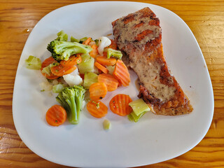 Salmon with Steamed Vegetables on Wooden Table