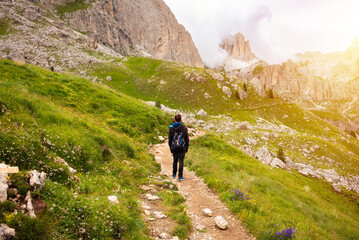 Fototapeta na wymiar Hiker walking on mountain hiking trail in Dolomite alps