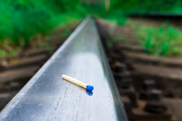 Matches on rails railroad tracks background, fire on railways concept