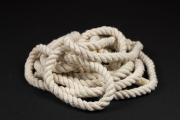 beige rope on dark background close up