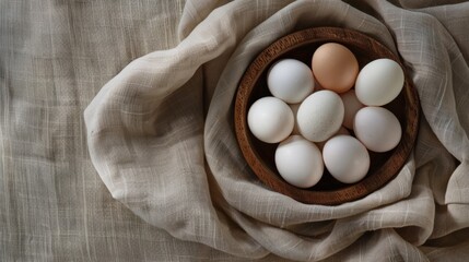 Top view of boiled eggs in wooden bowl on cotton fabric background with copy space. Boiled egg die