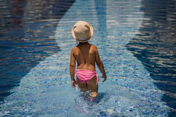 Little girl child in the swimming pool.